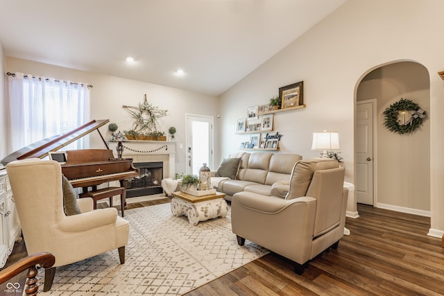 10585 Windward Dr, Indianapolis, IN 46234 - living area with wood finished floors, arched walkways, a fireplace with flush hearth, plenty of natural light, and recessed lighting