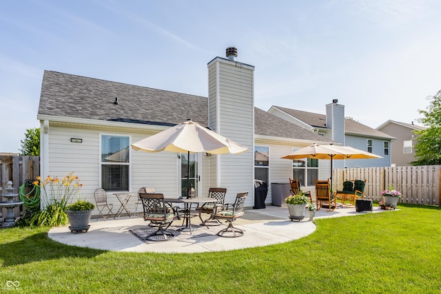 10585 Windward Dr, Indianapolis, IN 46234 - rear view of house featuring a patio, roof with shingles, and a chimney