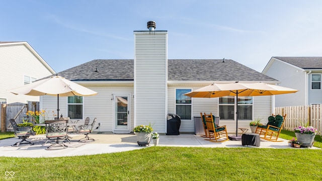10585 Windward Dr, Indianapolis, IN 46234 - back of house featuring a patio area, a chimney, and roof with shingles