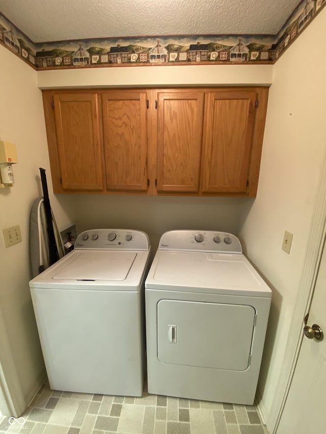 3910 S Baytree Ln, Bloomington, IN 47401 - laundry area featuring cabinet space, washing machine and dryer, and a textured ceiling