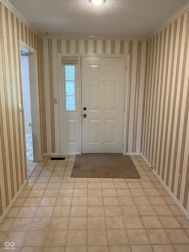 3910 S Baytree Ln, Bloomington, IN 47401 - entrance foyer with wallpapered walls, a textured ceiling, and crown molding
