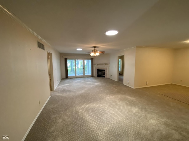 3910 S Baytree Ln, Bloomington, IN 47401 - unfurnished living room featuring carpet floors, a tile fireplace, ceiling fan, crown molding, and recessed lighting