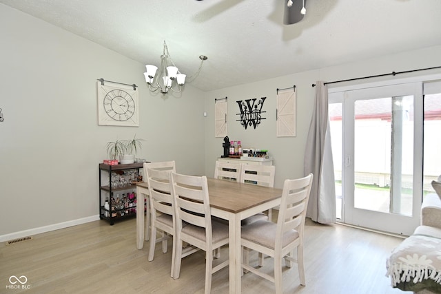 5936 Beau Jardin Dr, Indianapolis, IN 46237 - dining space featuring light wood finished floors, a chandelier, and a ceiling fan