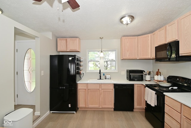 5936 Beau Jardin Dr, Indianapolis, IN 46237 - kitchen featuring black appliances, light brown cabinetry, light wood-type flooring, ceiling fan, and light countertops