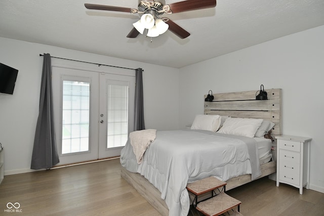 5936 Beau Jardin Dr, Indianapolis, IN 46237 - bedroom featuring light wood-style flooring, french doors, a ceiling fan, and access to exterior