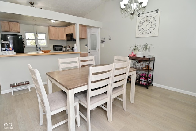 5936 Beau Jardin Dr, Indianapolis, IN 46237 - dining area featuring light wood-style flooring, a chandelier, and vaulted ceiling