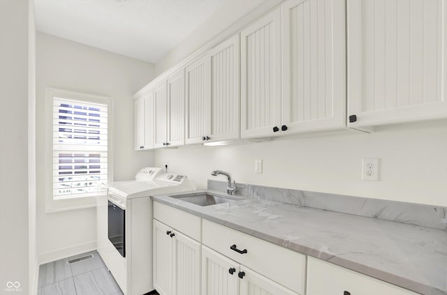 11137 Peppermill Ln, Fishers, IN 46037 - laundry room with cabinet space, separate washer and dryer, and light marble finish flooring