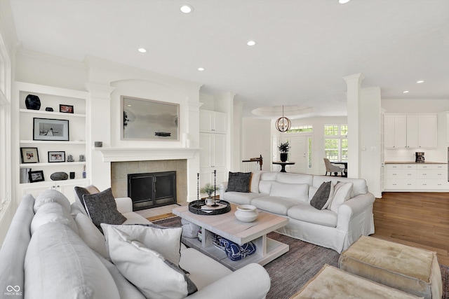 11137 Peppermill Ln, Fishers, IN 46037 - living area with recessed lighting, wood finished floors, a tile fireplace, built in shelves, and ornamental molding