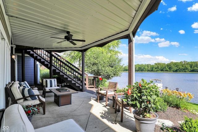 11137 Peppermill Ln, Fishers, IN 46037 - view of patio / terrace with stairway, a water view, a ceiling fan, and an outdoor living space with a fire pit