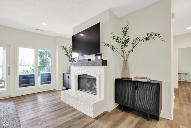 11137 Peppermill Ln, Fishers, IN 46037 - unfurnished living room featuring a fireplace, wood finished floors, and recessed lighting