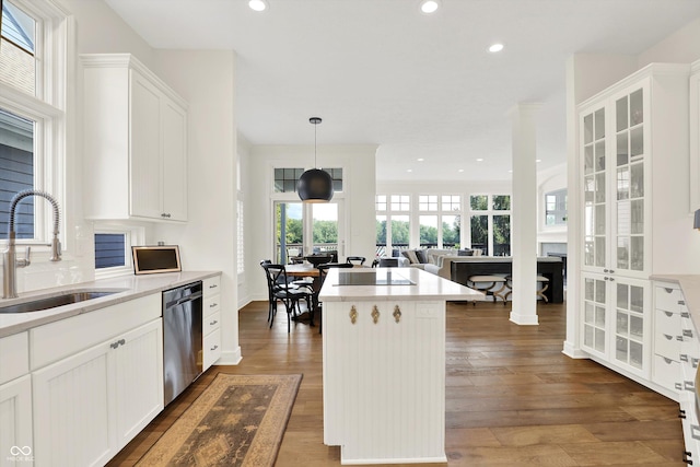 11137 Peppermill Ln, Fishers, IN 46037 - kitchen featuring dishwasher, a kitchen island, light countertops, glass insert cabinets, and recessed lighting