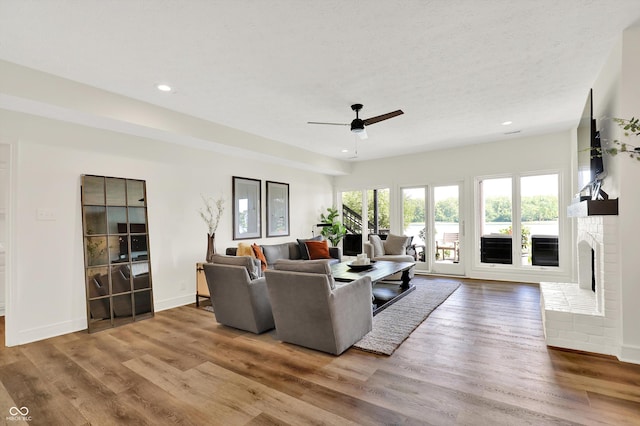 11137 Peppermill Ln, Fishers, IN 46037 - living area with recessed lighting, wood finished floors, ceiling fan, and a brick fireplace