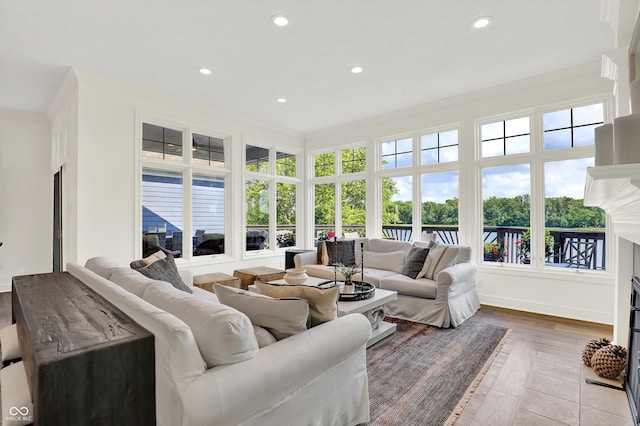 11137 Peppermill Ln, Fishers, IN 46037 - living area featuring recessed lighting, plenty of natural light, wood finished floors, and crown molding