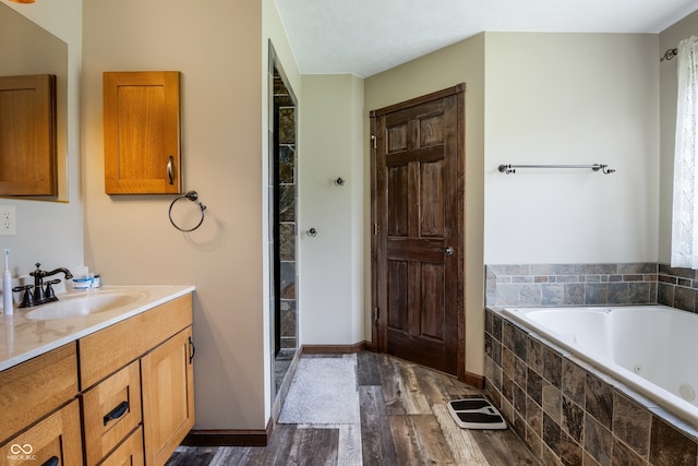 20136 Stone Church Rd, Laurel, IN 47024 - full bath featuring a whirlpool tub, vanity, wood finished floors, and a shower stall