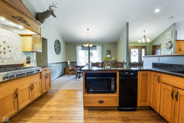 20136 Stone Church Rd, Laurel, IN 47024 - kitchen with a chandelier, black appliances, vaulted ceiling, decorative light fixtures, and decorative backsplash