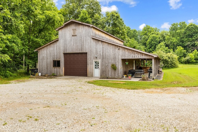 20136 Stone Church Rd, Laurel, IN 47024 - view of side of home featuring driveway, a detached garage, an outdoor structure, a barn, and a lawn