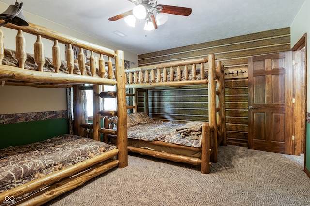 20136 Stone Church Rd, Laurel, IN 47024 - carpeted bedroom with rustic walls and ceiling fan