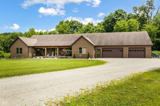 20136 Stone Church Rd, Laurel, IN 47024 - ranch-style home featuring an attached garage, brick siding, a front yard, gravel driveway, and covered porch