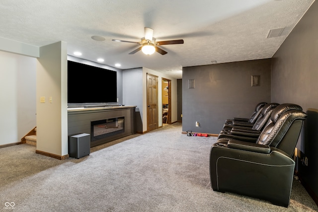 20136 Stone Church Rd, Laurel, IN 47024 - carpeted living area featuring a ceiling fan, a glass covered fireplace, stairs, a textured ceiling, and recessed lighting