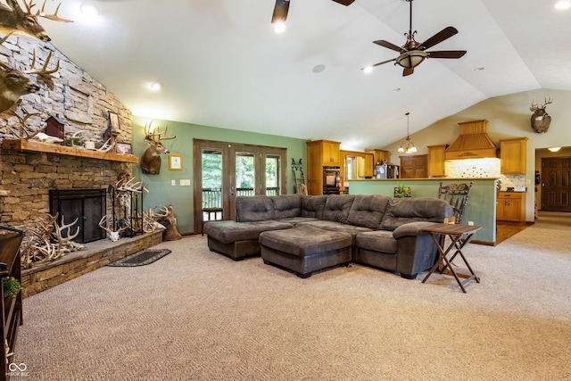 20136 Stone Church Rd, Laurel, IN 47024 - living room featuring light colored carpet, vaulted ceiling, french doors, ceiling fan, and a stone fireplace