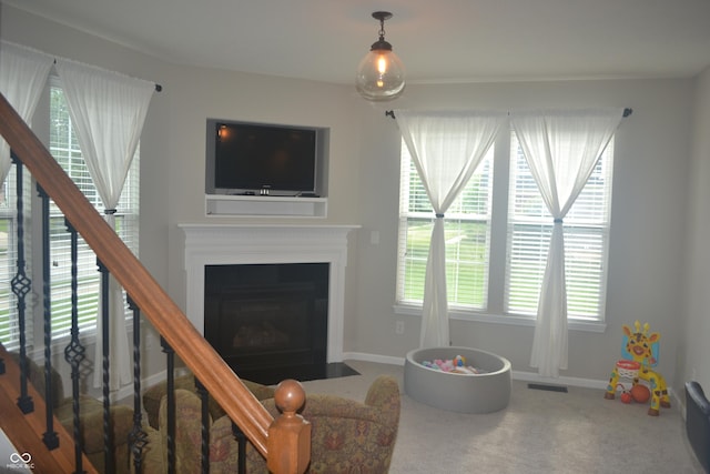 10166 Ranford Blvd, Fishers, IN 46040 - carpeted living area featuring stairway and a fireplace with flush hearth