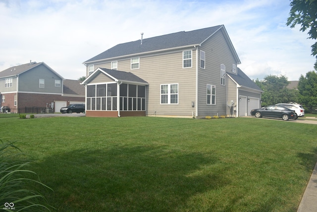 10166 Ranford Blvd, Fishers, IN 46040 - back of house featuring a sunroom, a lawn, and a garage