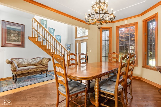 2320 Whispering Way, Indianapolis, IN 46239 - dining room featuring wood finished floors, healthy amount of natural light, a chandelier, stairs, and crown molding