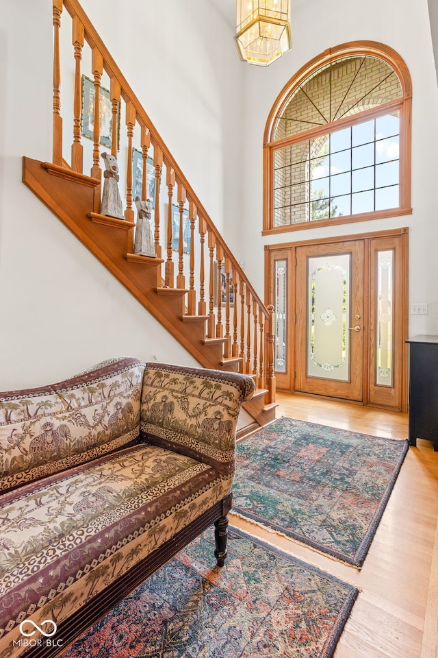 2320 Whispering Way, Indianapolis, IN 46239 - foyer featuring a high ceiling, stairway, a chandelier, and wood finished floors