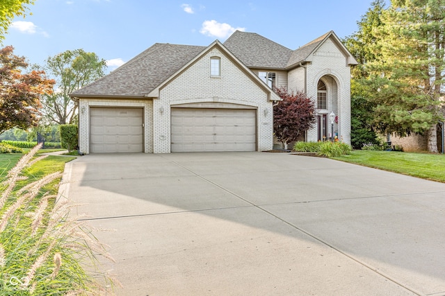 2320 Whispering Way, Indianapolis, IN 46239 - traditional-style home featuring brick siding, concrete driveway, a garage, and a shingled roof