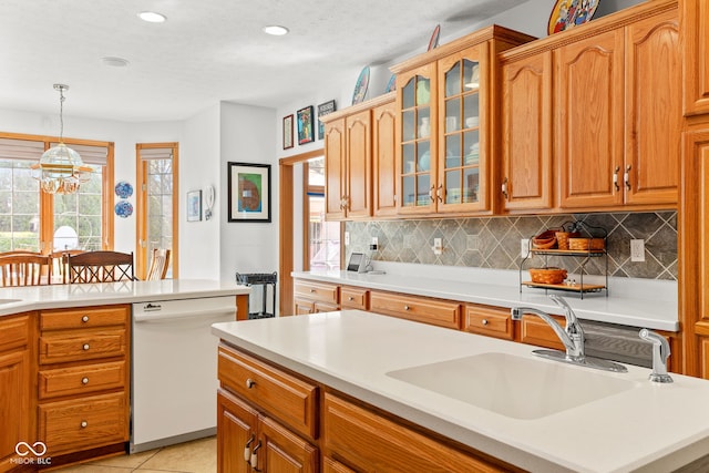 2320 Whispering Way, Indianapolis, IN 46239 - kitchen with dishwasher, light countertops, tasteful backsplash, glass insert cabinets, and recessed lighting