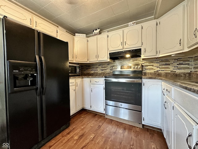 329 S Lockburn St, Indianapolis, IN 46241 - kitchen featuring stainless steel appliances, under cabinet range hood, dark countertops, and dark wood-style flooring