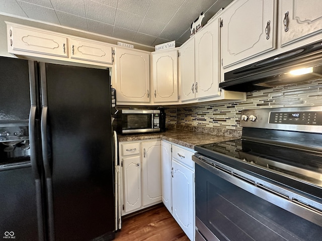 329 S Lockburn St, Indianapolis, IN 46241 - kitchen with appliances with stainless steel finishes, under cabinet range hood, dark countertops, decorative backsplash, and white cabinetry