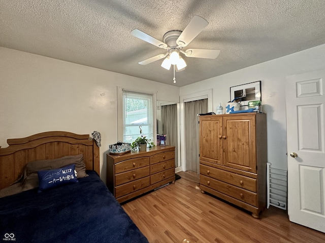 329 S Lockburn St, Indianapolis, IN 46241 - bedroom with wood finished floors, a textured ceiling, and ceiling fan