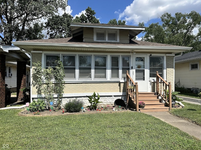 329 S Lockburn St, Indianapolis, IN 46241 - bungalow with brick siding, entry steps, and a front lawn