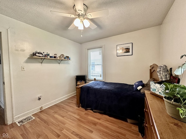329 S Lockburn St, Indianapolis, IN 46241 - bedroom with light wood-style flooring, a textured ceiling, and a ceiling fan
