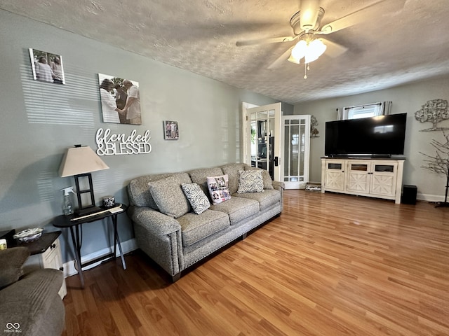 329 S Lockburn St, Indianapolis, IN 46241 - living room featuring light wood-type flooring, healthy amount of natural light, ceiling fan, and a textured ceiling