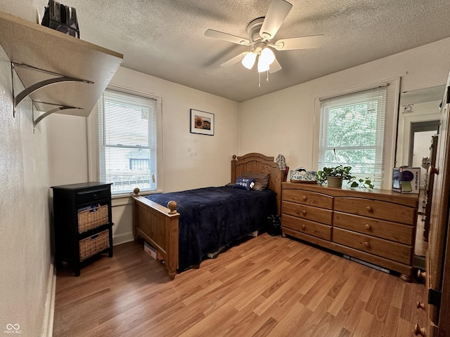 329 S Lockburn St, Indianapolis, IN 46241 - bedroom featuring light wood-style floors, a textured ceiling, and a ceiling fan