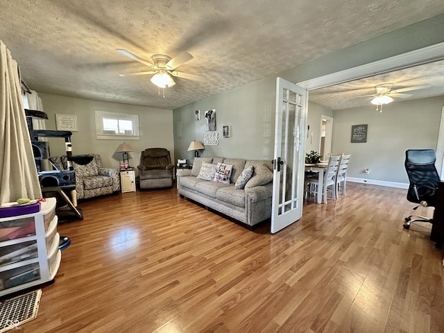 329 S Lockburn St, Indianapolis, IN 46241 - living area with ceiling fan, light wood-style floors, and a textured ceiling