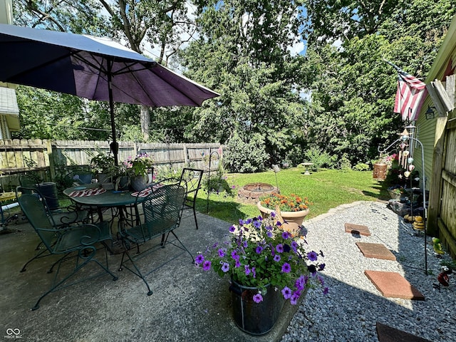 329 S Lockburn St, Indianapolis, IN 46241 - fenced backyard with outdoor dining area, a patio area, and an outdoor fire pit