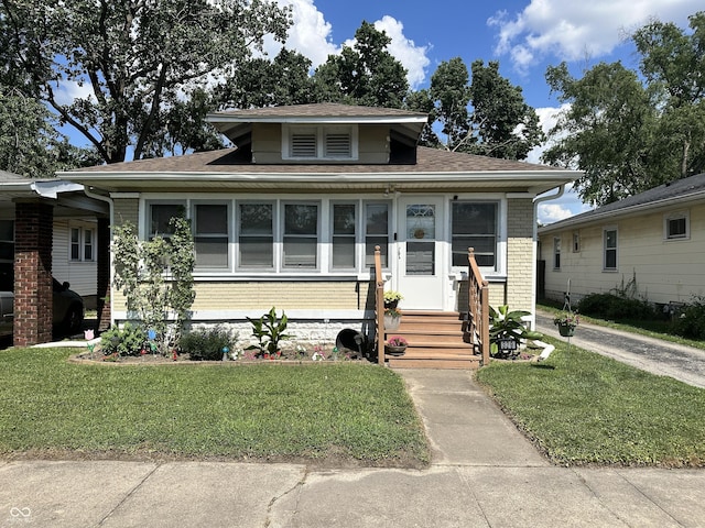 329 S Lockburn St, Indianapolis, IN 46241 - bungalow with entry steps, a front yard, and roof with shingles