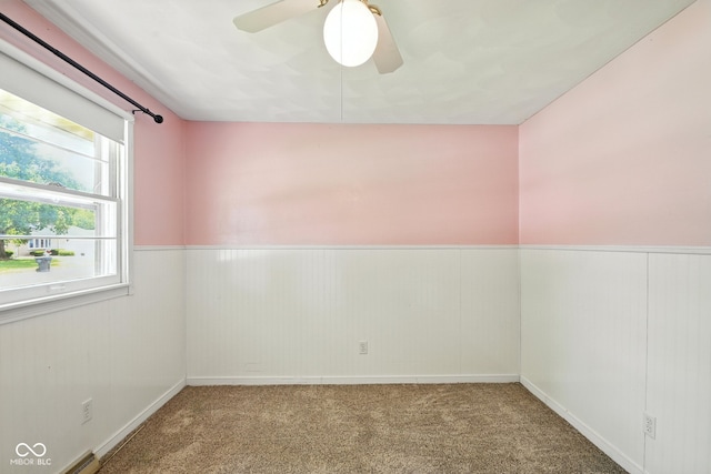 3504 White River Ct, Anderson, IN 46012 - empty room with wainscoting, carpet flooring, and ceiling fan