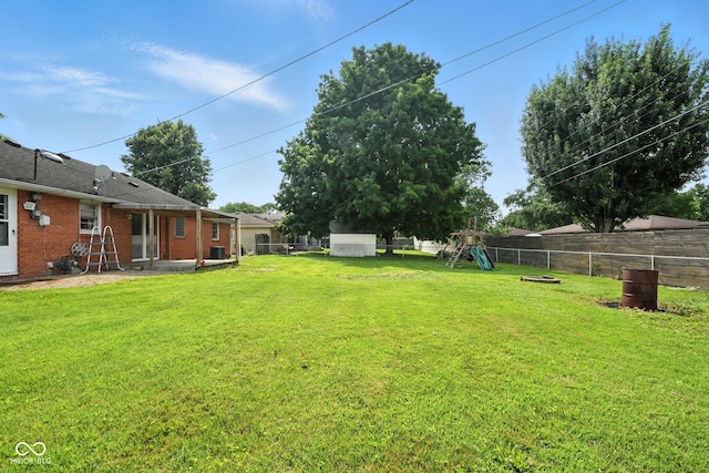 3504 White River Ct, Anderson, IN 46012 - fenced backyard featuring a playground