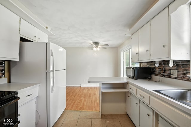 3504 White River Ct, Anderson, IN 46012 - kitchen featuring black microwave, light tile patterned floors, a ceiling fan, light countertops, and backsplash