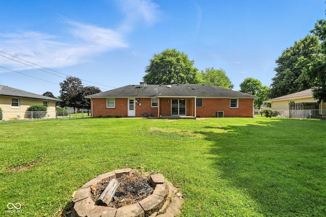 3504 White River Ct, Anderson, IN 46012 - back of property with an outdoor fire pit, a fenced backyard, and brick siding