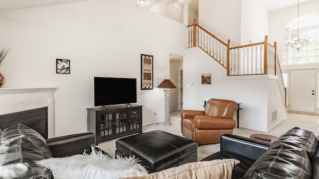 13390 Grosbeak Ct, Carmel, IN 46033 - living area with high vaulted ceiling, stairs, a glass covered fireplace, carpet flooring, and a chandelier