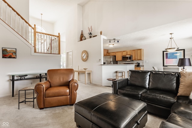 13390 Grosbeak Ct, Carmel, IN 46033 - living area with light carpet, a high ceiling, and stairway