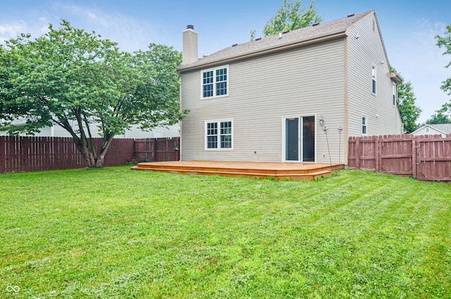 5541 Lippan Way, Indianapolis, IN 46221 - back of property featuring a chimney, a fenced backyard, and a wooden deck
