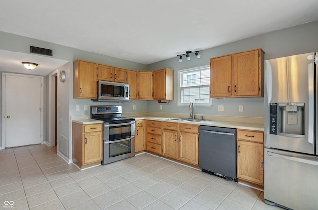 5541 Lippan Way, Indianapolis, IN 46221 - kitchen with appliances with stainless steel finishes, light countertops, and light tile patterned flooring