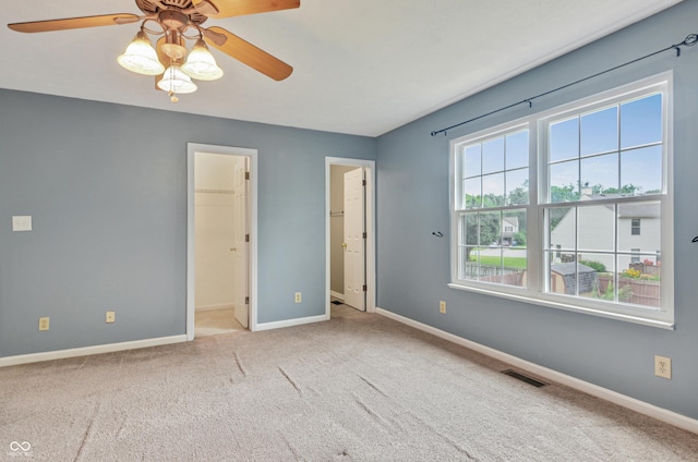 5541 Lippan Way, Indianapolis, IN 46221 - unfurnished bedroom with carpet flooring, a ceiling fan, and ensuite bath