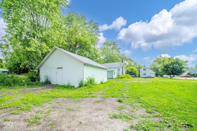 2627 Chase St, Anderson, IN 46016 - view of grassy yard featuring an outbuilding and a detached garage